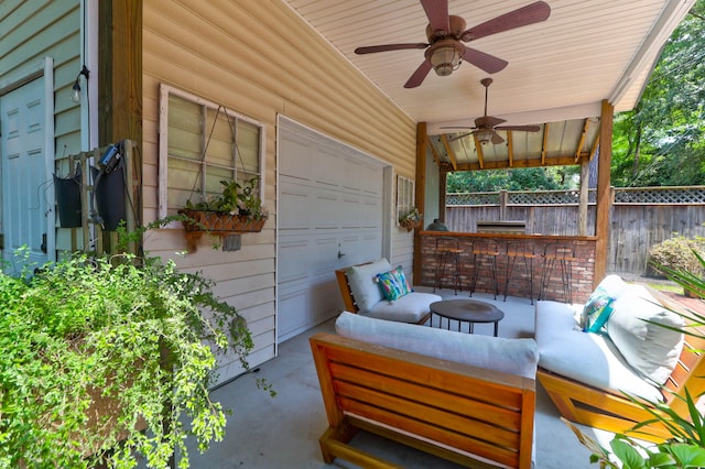 view of patio / terrace featuring ceiling fan and an outdoor living space with a fire pit