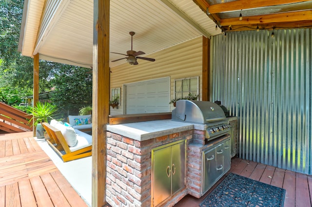 deck featuring ceiling fan, exterior kitchen, and a grill