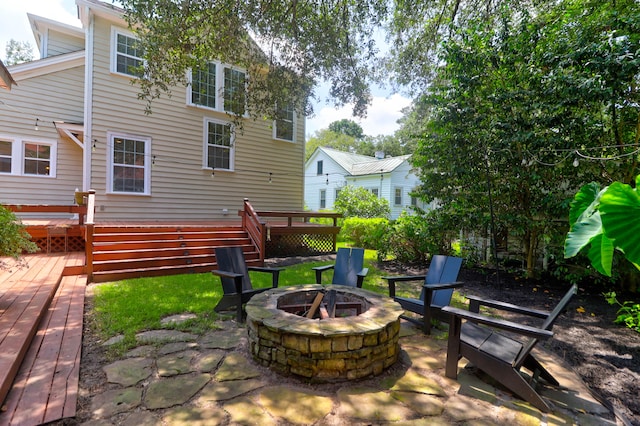 view of patio featuring a wooden deck and a fire pit