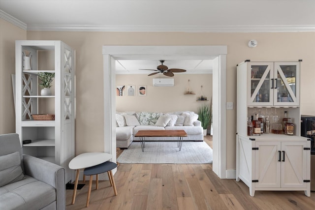 living area with light wood-style floors, ceiling fan, a wall mounted air conditioner, ornamental molding, and a dry bar