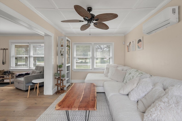 living room with a wall mounted air conditioner, wood finished floors, a ceiling fan, and crown molding