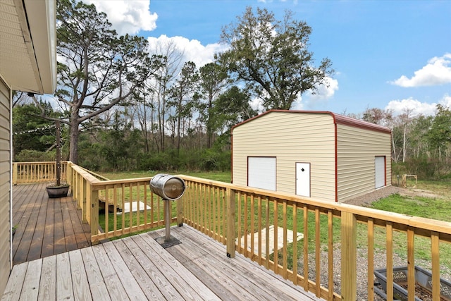 deck featuring a detached garage, an outbuilding, and a yard