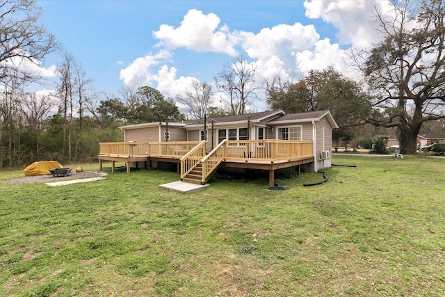 back of house featuring a wooden deck and a lawn