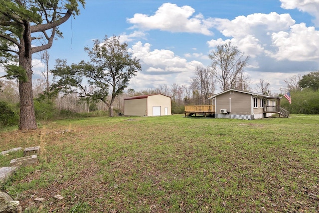 view of green lawn featuring a garage, a deck, and an outdoor structure