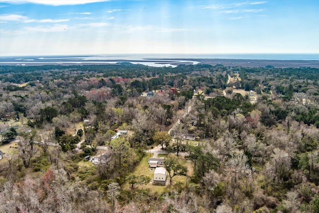 view of property location featuring a forest