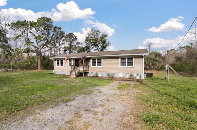 manufactured / mobile home featuring a front yard and cooling unit