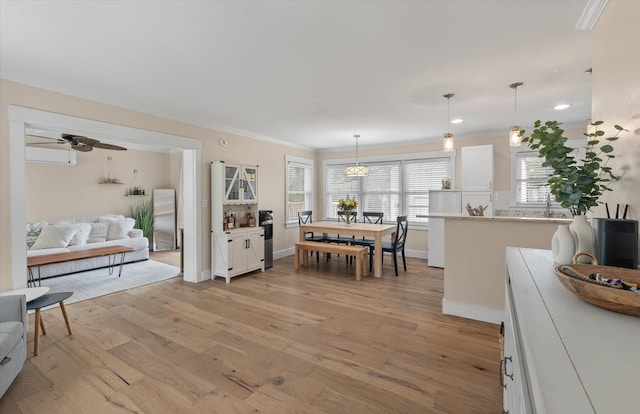 dining area with ornamental molding, light wood-style flooring, a ceiling fan, baseboards, and recessed lighting