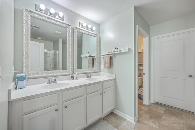 bathroom featuring double vanity, a sink, visible vents, and a shower stall