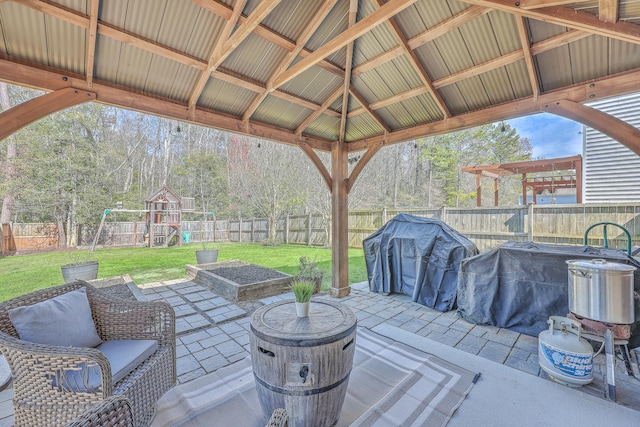 view of patio with a playground, grilling area, a gazebo, and a fenced backyard