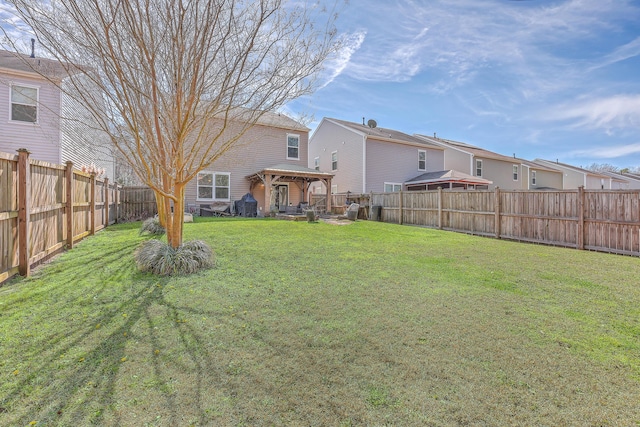 view of yard featuring a fenced backyard, a residential view, and a gazebo