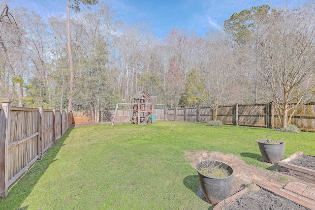 view of yard featuring a playground and a fenced backyard