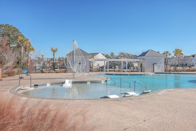 pool with a patio area, fence, and a pergola