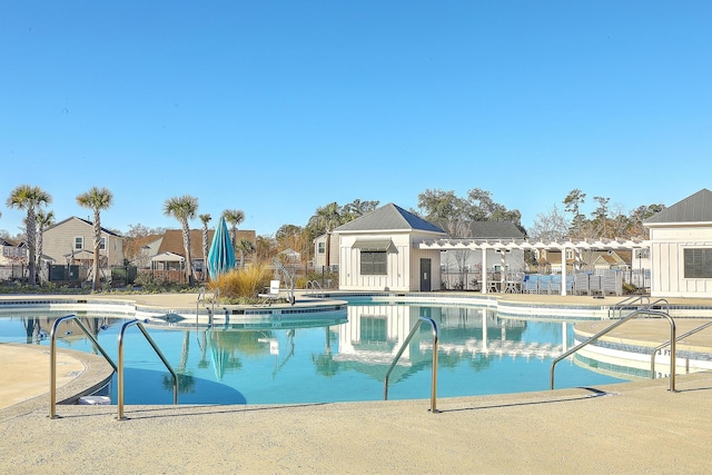 pool featuring a patio area, a residential view, and fence