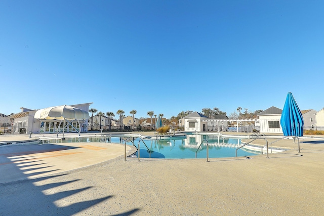 pool featuring a patio and a residential view