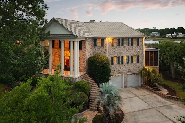 2834 Parkers Landing Rd, Mount Pleasant, SC 29466 - neoclassical home featuring driveway, a garage, a standing seam roof, stairs, and a metal roof