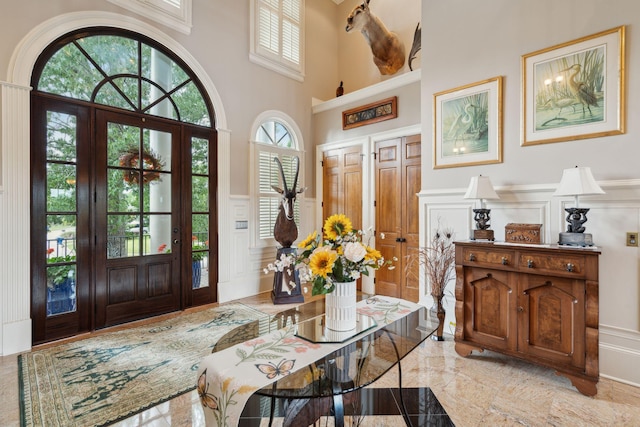 2834 Parkers Landing Rd, Mount Pleasant, SC 29466 - foyer featuring a decorative wall, marble tiled flooring, a wainscoted wall, and a high ceiling