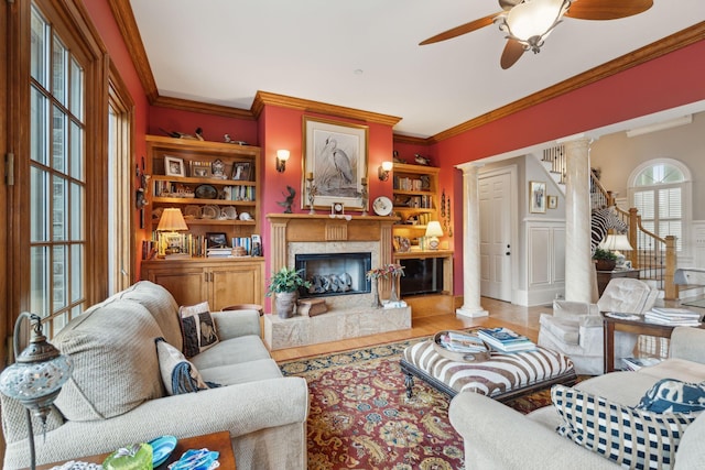 2834 Parkers Landing Rd, Mount Pleasant, SC 29466 - living area with ornate columns, a ceiling fan, wood finished floors, ornamental molding, and a high end fireplace