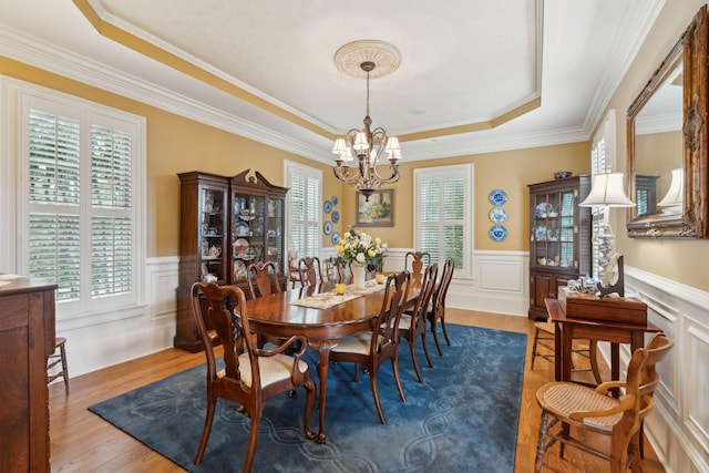 2834 Parkers Landing Rd, Mount Pleasant, SC 29466 - dining area featuring a raised ceiling, a chandelier, plenty of natural light, a wainscoted wall, and wood finished floors