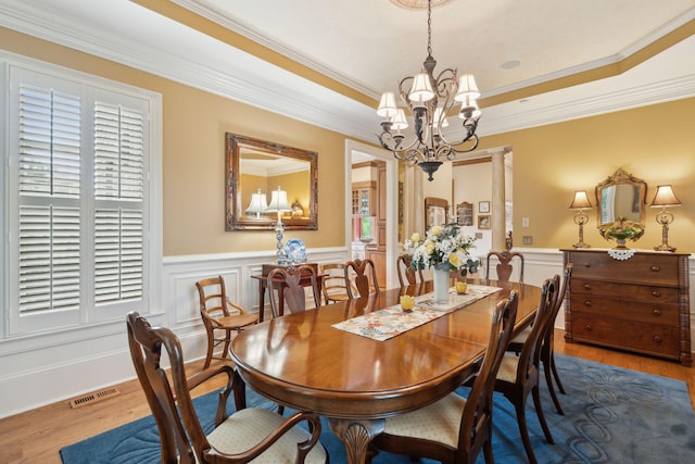 2834 Parkers Landing Rd, Mount Pleasant, SC 29466 - dining area featuring a chandelier, a wainscoted wall, crown molding, and wood finished floors