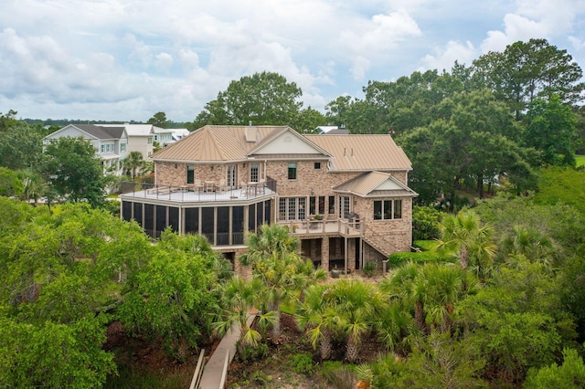 2834 Parkers Landing Rd, Mount Pleasant, SC 29466 - rear view of house featuring a sunroom, a metal roof, a standing seam roof, stairs, and a balcony
