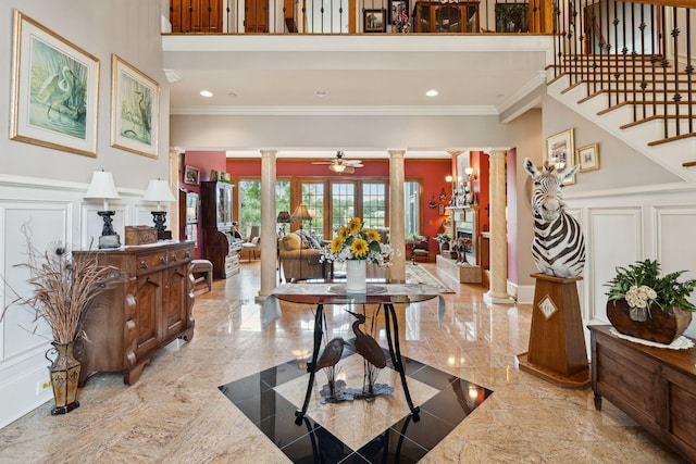 2834 Parkers Landing Rd, Mount Pleasant, SC 29466 - foyer entrance featuring ornate columns, a decorative wall, crown molding, ceiling fan, and a wainscoted wall