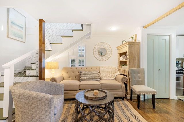 living room featuring hardwood / wood-style floors and ornamental molding