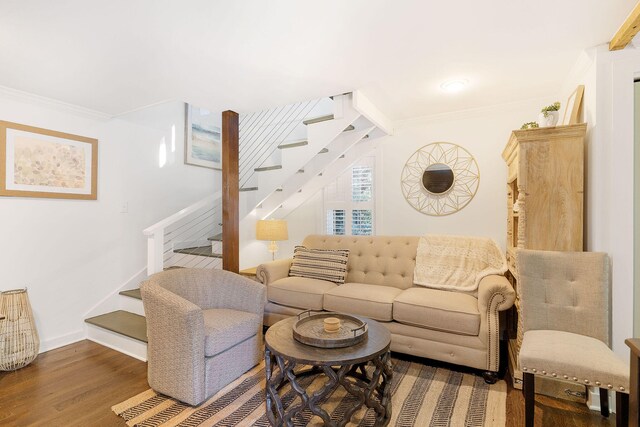 living room with dark hardwood / wood-style flooring and crown molding