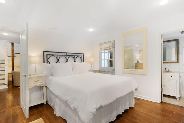 bedroom featuring dark hardwood / wood-style floors, ornamental molding, and sink