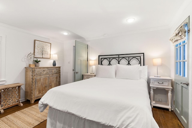 bedroom with crown molding and dark wood-type flooring