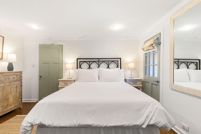 bedroom with crown molding and dark wood-type flooring