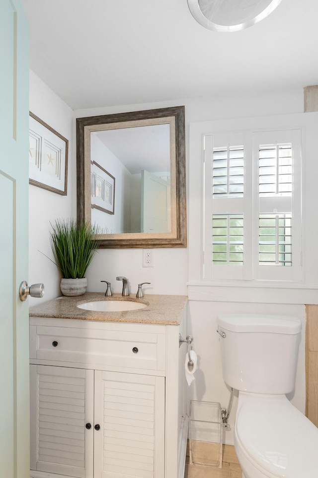 bathroom featuring vanity and toilet