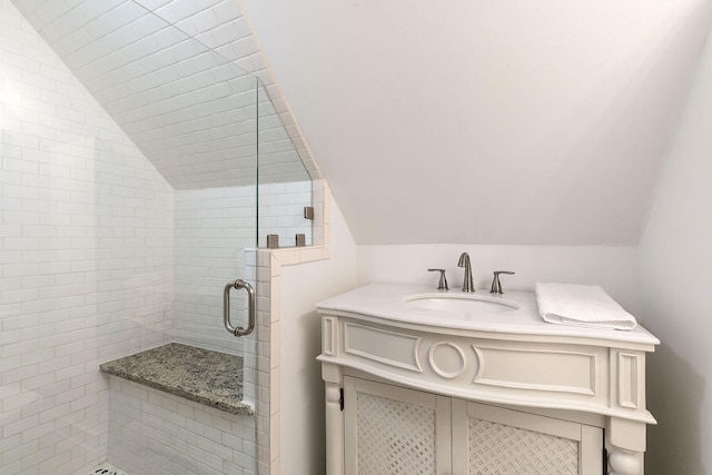 bathroom featuring vanity, an enclosed shower, and vaulted ceiling