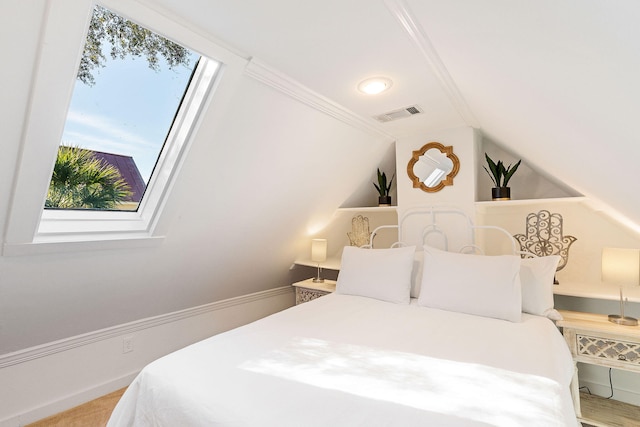 bedroom with vaulted ceiling and crown molding