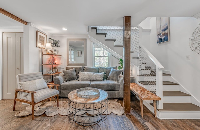 living room featuring crown molding and hardwood / wood-style flooring