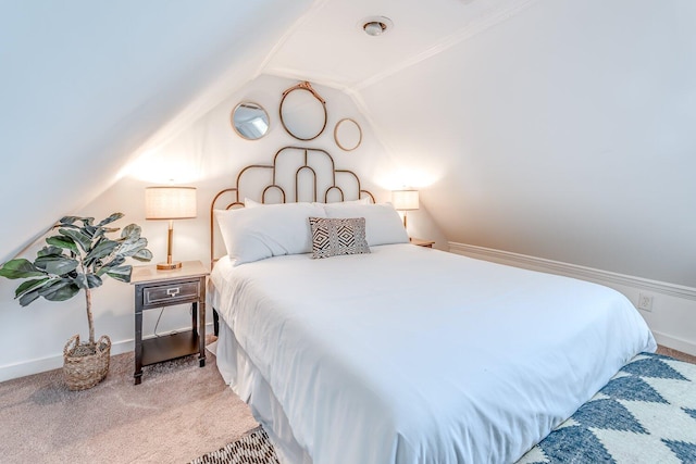 carpeted bedroom with lofted ceiling