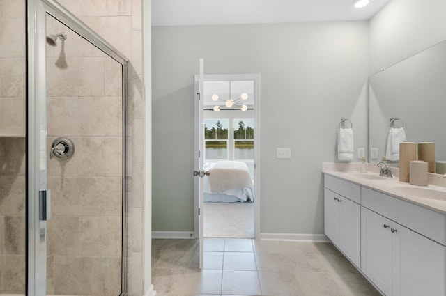 bathroom featuring vanity, tile patterned flooring, and a shower with shower door