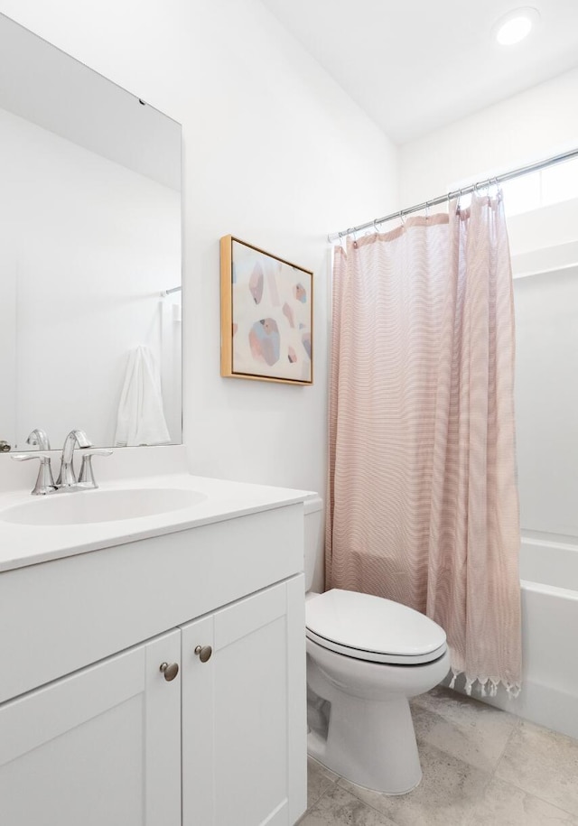 full bathroom with vanity, toilet, and shower / bath combo with shower curtain