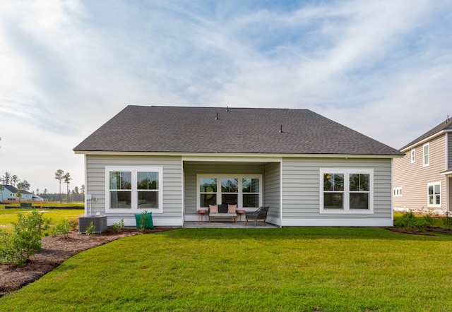 back of property featuring a lawn and a patio area