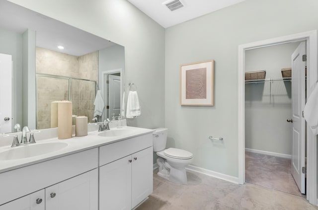 bathroom featuring walk in shower, vanity, and toilet