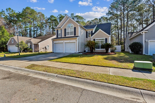 traditional home with driveway, an attached garage, and a front yard