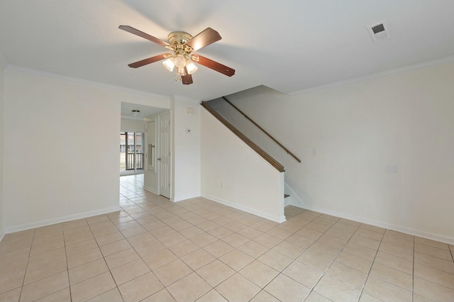 tiled spare room with ornamental molding and ceiling fan