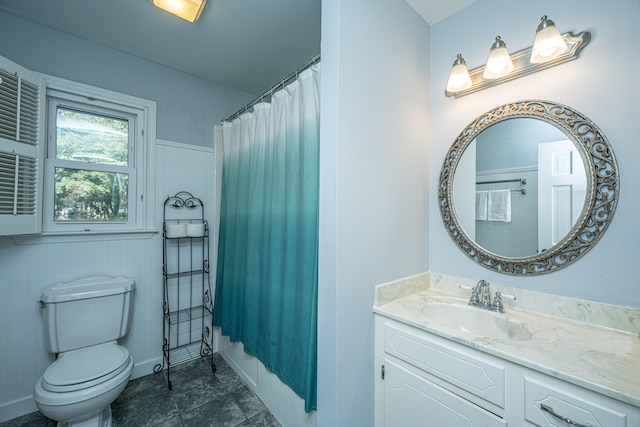 bathroom with toilet, walk in shower, and vanity