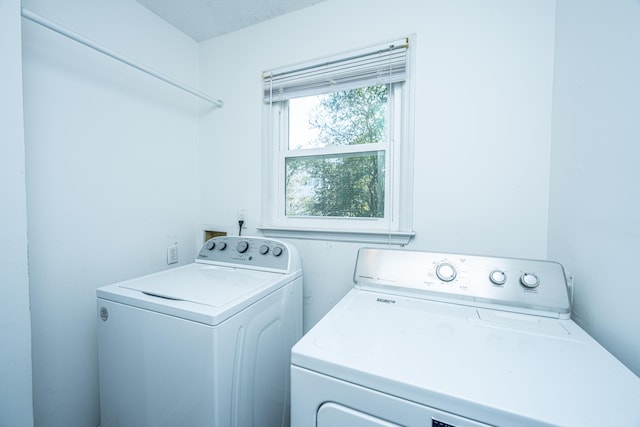 laundry room with washer and dryer and a textured ceiling