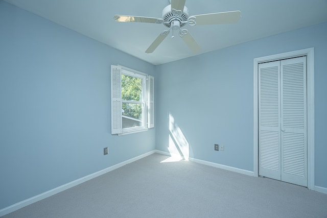 unfurnished bedroom with a closet, ceiling fan, and carpet flooring