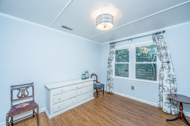 bedroom with crown molding and dark wood-type flooring