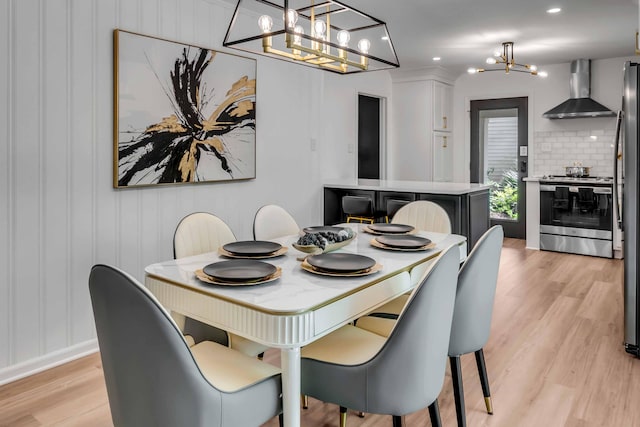 dining area featuring a chandelier, light wood-style floors, and recessed lighting