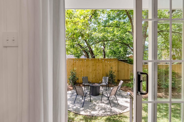 view of patio / terrace featuring an outdoor fire pit and fence