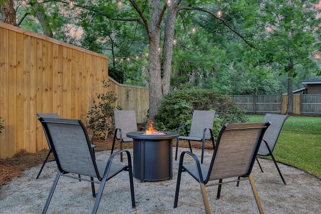 view of patio / terrace with an outdoor fire pit and a fenced backyard