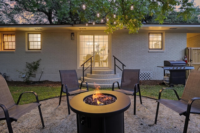 view of patio / terrace featuring grilling area, an outdoor fire pit, and entry steps