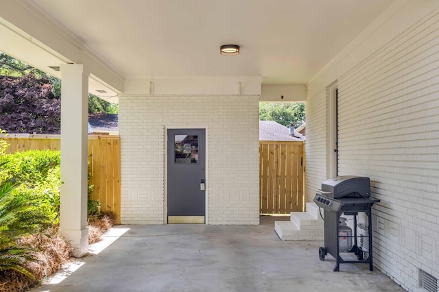 view of patio with area for grilling and fence